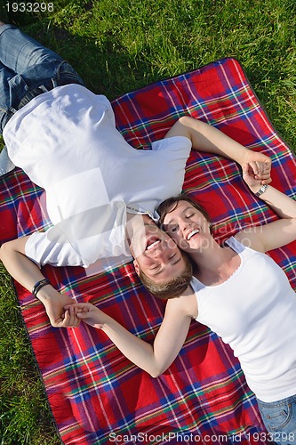 Image of happy young couple having a picnic outdoor