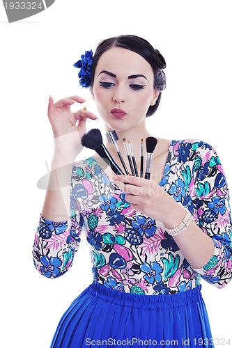 Image of beautiful young woman applying makeup