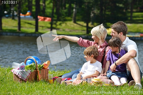 Image of Happy family playing together in a picnic outdoors