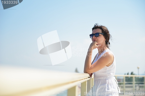 Image of young woman with spreading arms to sky