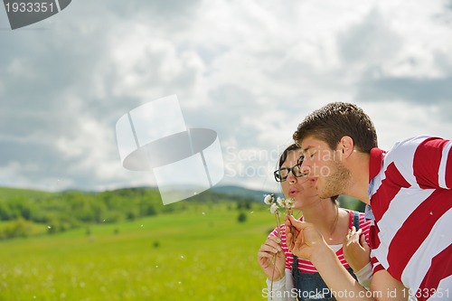 Image of Portrait of romantic young couple smiling together outdoor