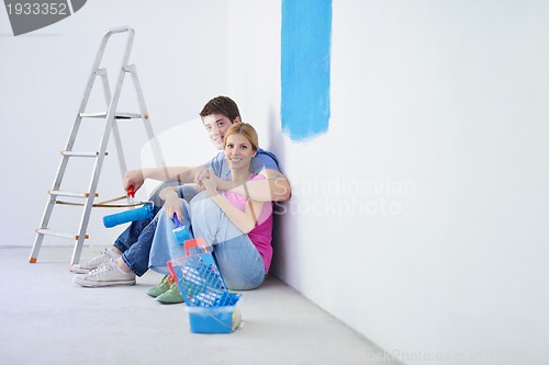 Image of happy young cople relaxing after painting in new home