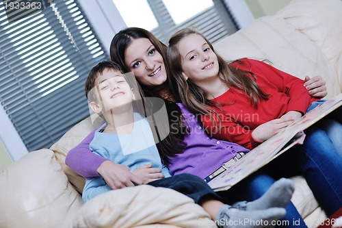 Image of young mom play with their kids at home and reading book
