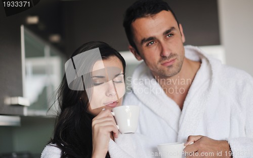 Image of Young love couple taking fresh morning cup of coffee