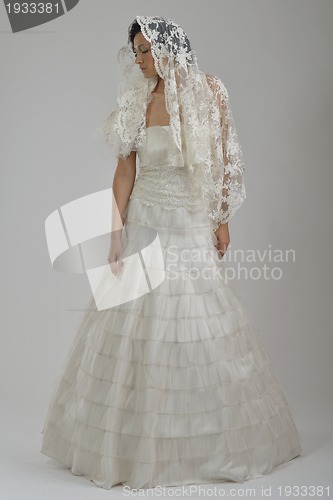 Image of elegant woman in fashionable dress posing in the studio