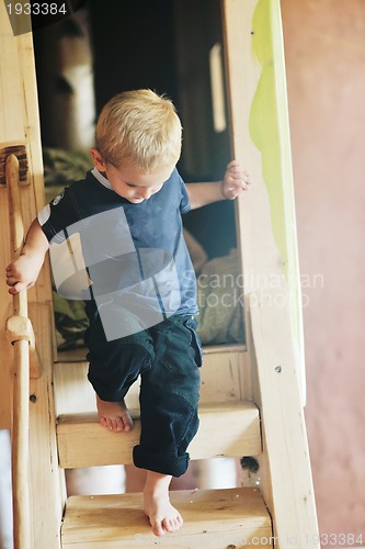 Image of beautiful young child making first steps