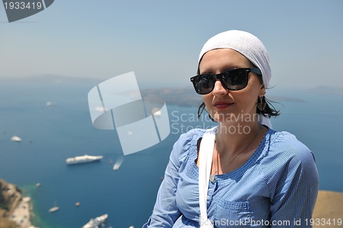 Image of Greek woman on the streets of Oia, Santorini, Greece