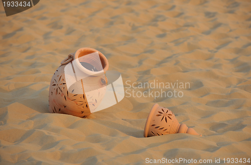 Image of arabic pot in sand