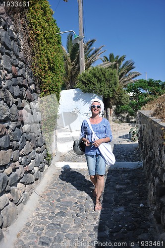 Image of Greek woman on the streets of Oia, Santorini, Greece