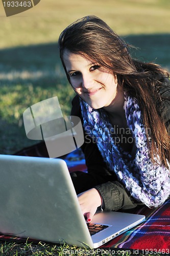 Image of young teen girl work on laptop outdoor