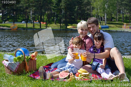 Image of Happy family playing together in a picnic outdoors