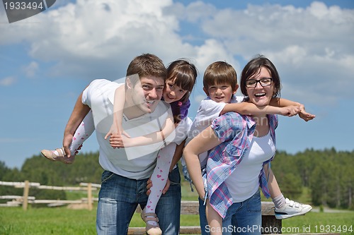 Image of happy young family have fun outdoors