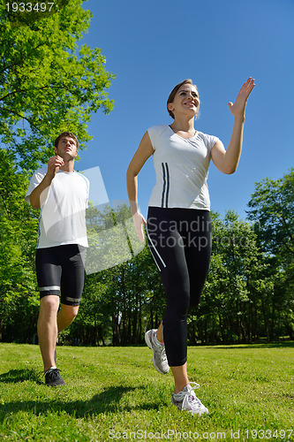 Image of Young couple jogging