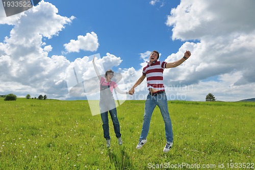 Image of Portrait of romantic young couple smiling together outdoor