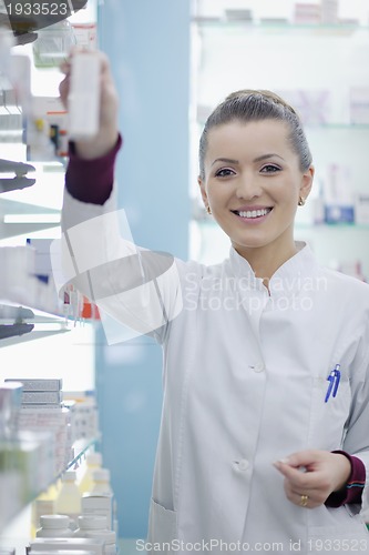 Image of pharmacist chemist woman standing in pharmacy drugstore