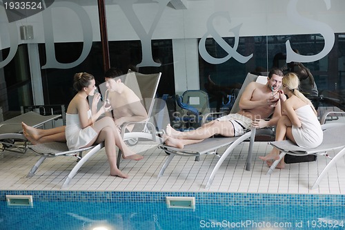 Image of young people group at spa swimming pool