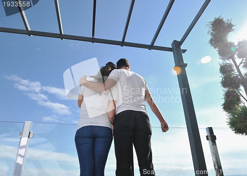 Image of couple relaxing on balcony