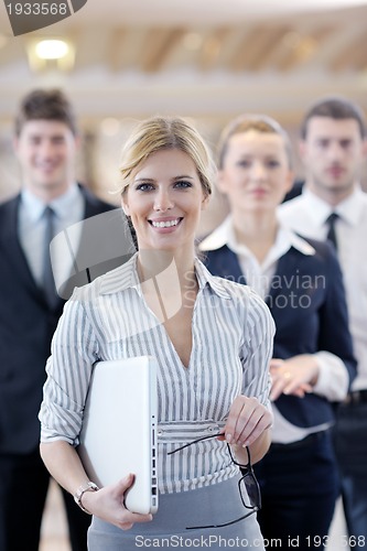 Image of business woman standing with her staff at conference