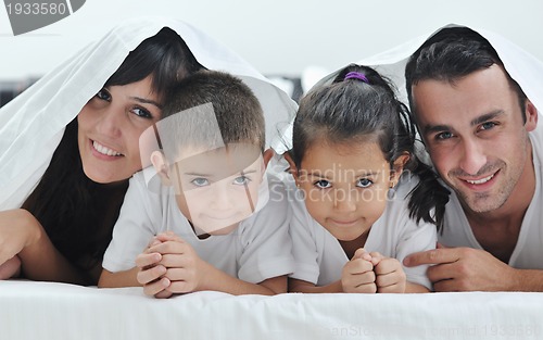 Image of happy young Family in their bedroom