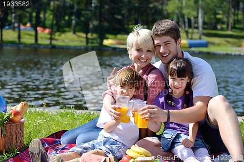 Image of Happy family playing together in a picnic outdoors