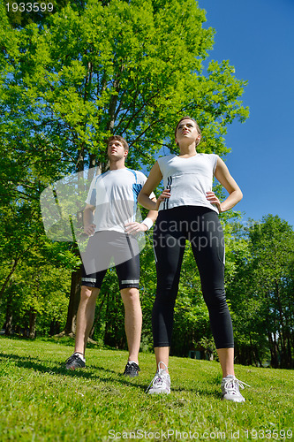 Image of Couple doing stretching exercise  after jogging