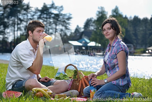 Image of happy young couple having a picnic outdoor