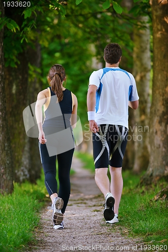 Image of Young couple jogging