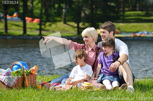 Image of Happy family playing together in a picnic outdoors