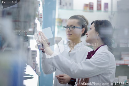 Image of team of pharmacist chemist woman  in pharmacy drugstore