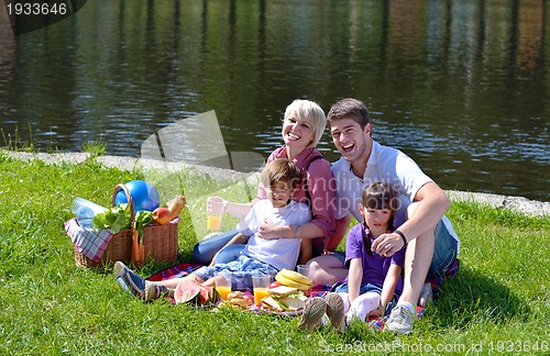 Image of Happy family playing together in a picnic outdoors