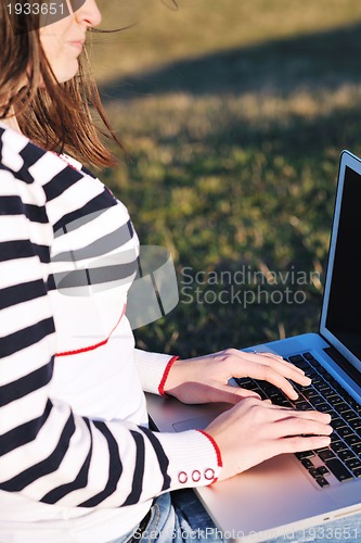 Image of young teen girl work on laptop outdoor