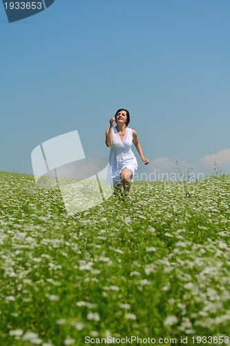 Image of Young happy woman in green field