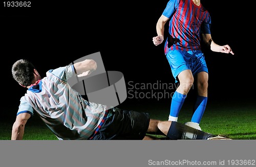 Image of football players in competition for the ball