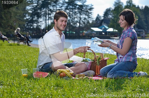 Image of happy young couple having a picnic outdoor