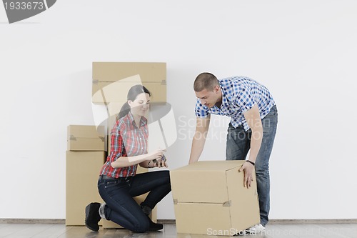 Image of Young couple moving in new home