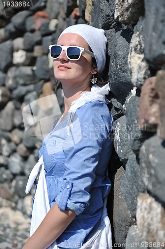 Image of Greek woman on the streets of Oia, Santorini, Greece