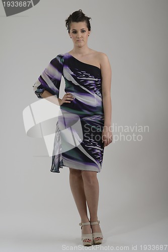 Image of elegant woman in fashionable dress posing in the studio
