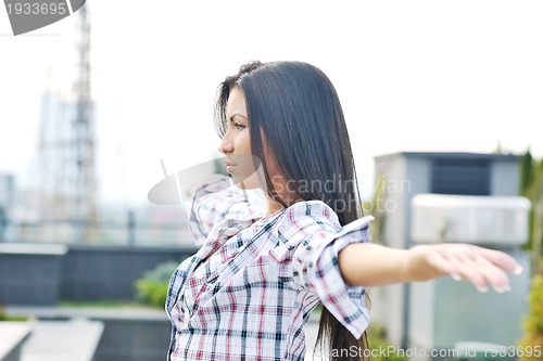 Image of beautiful young lady posing in garden
