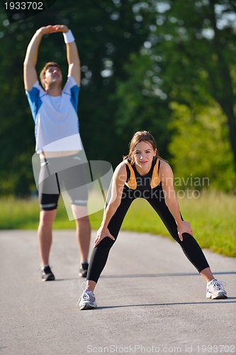 Image of Couple doing stretching exercise  after jogging