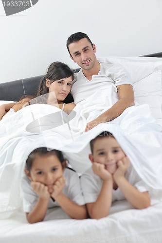 Image of happy young Family in their bedroom