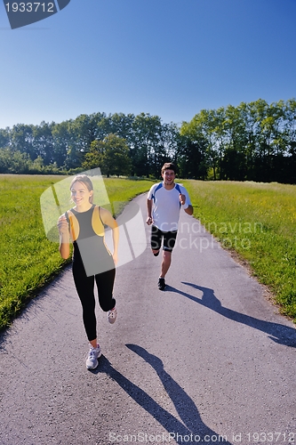 Image of Young couple jogging