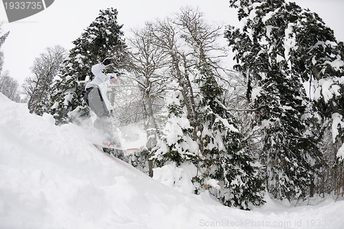 Image of snowboarder on fresh deep snow