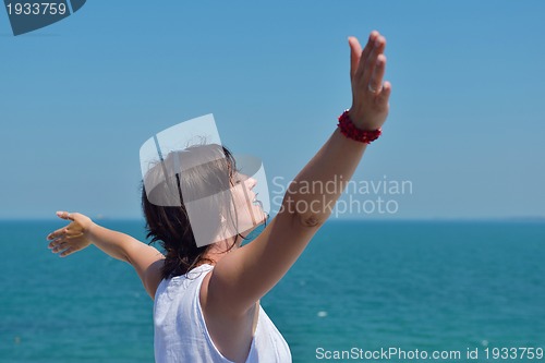Image of happy young woman with spreading arms to sky