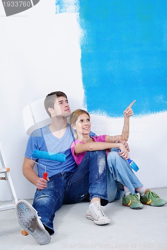 Image of happy young cople relaxing after painting in new home