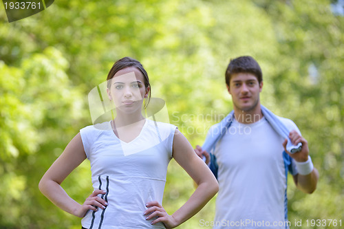 Image of Couple doing stretching exercise  after jogging
