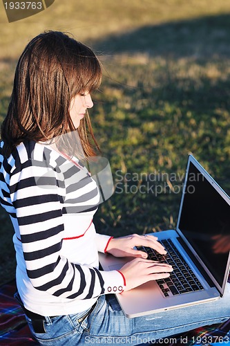 Image of young teen girl work on laptop outdoor