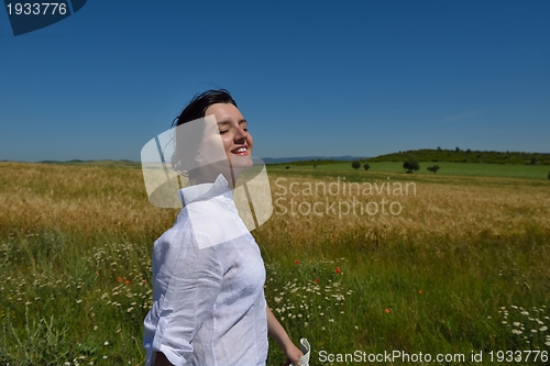 Image of young woman in wheat field at summer