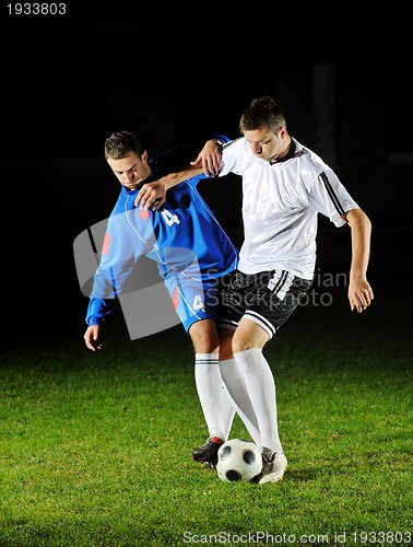 Image of football players in action for the ball