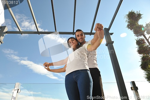 Image of couple relaxing on balcony