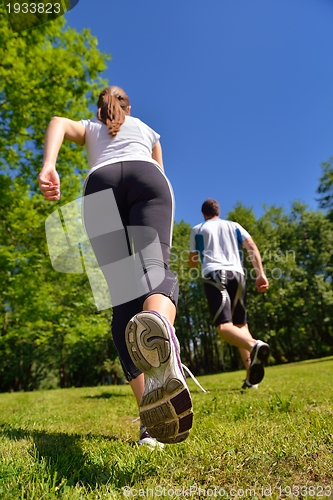 Image of Young couple jogging at morning